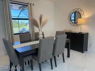 Dining area featuring marble finish flooring