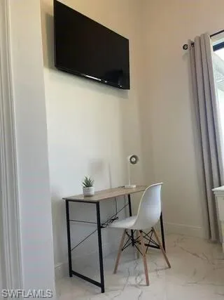 Office featuring marble finish floors and baseboards