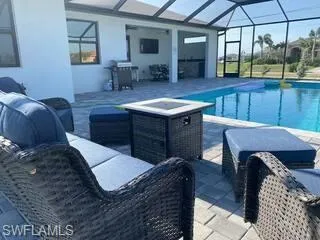 Outdoor pool with an outdoor hangout area, a patio area, and a lanai