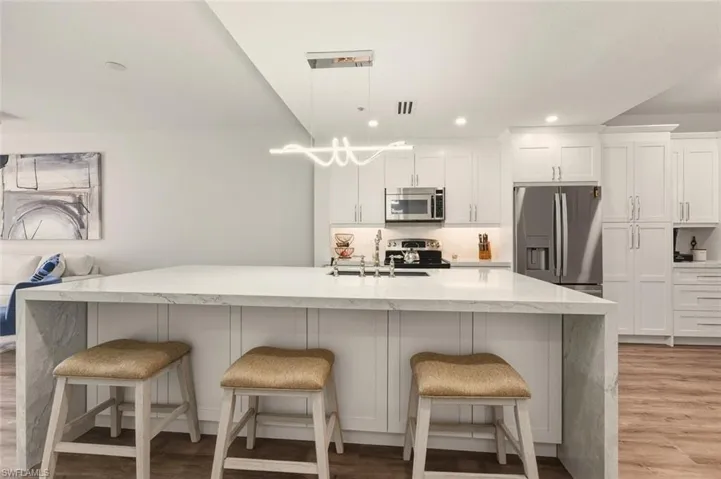 Kitchen with stainless steel appliances and a breakfast bar