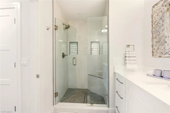 Bathroom with a stall shower and vanity