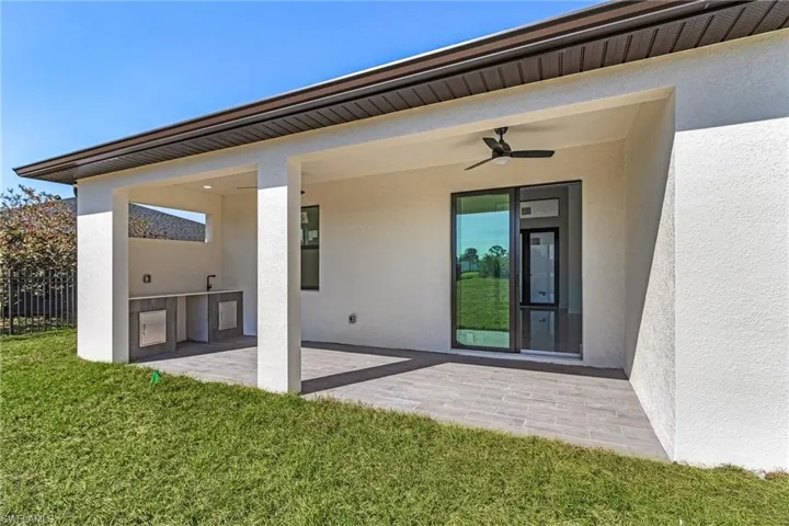 View of patio featuring exterior kitchen and fence