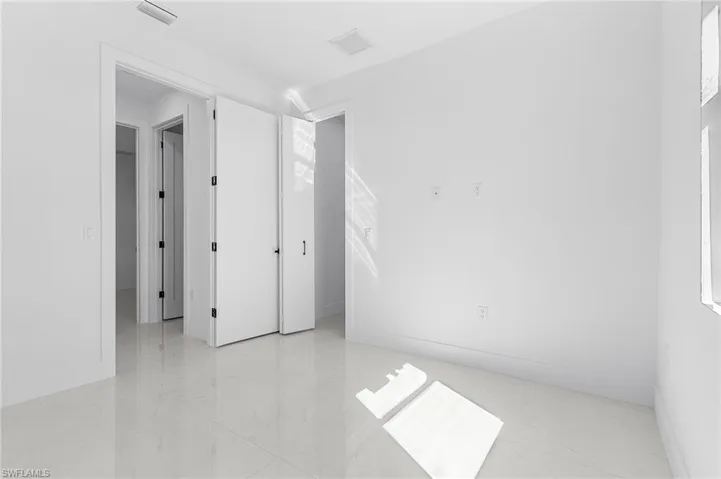 Spare room featuring visible vents, marble finish floor, and baseboards