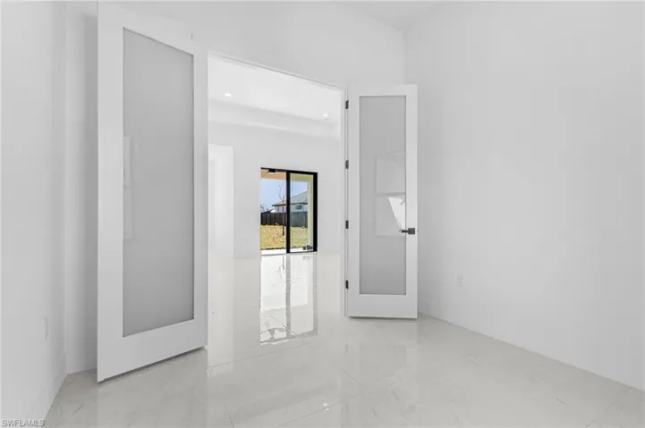 Empty room with french doors and marble finish floor