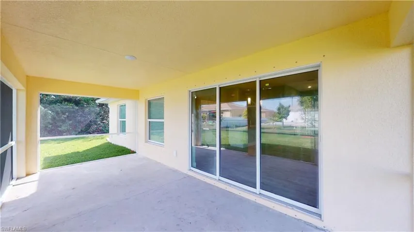 View of patio featuring a sunroom