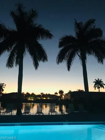 Pool #2 at dusk featuring a water view