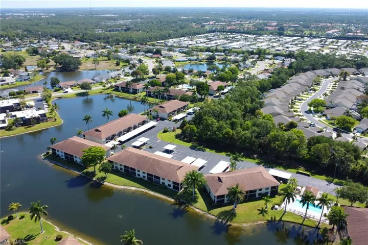 Birds eye view of property with a water view