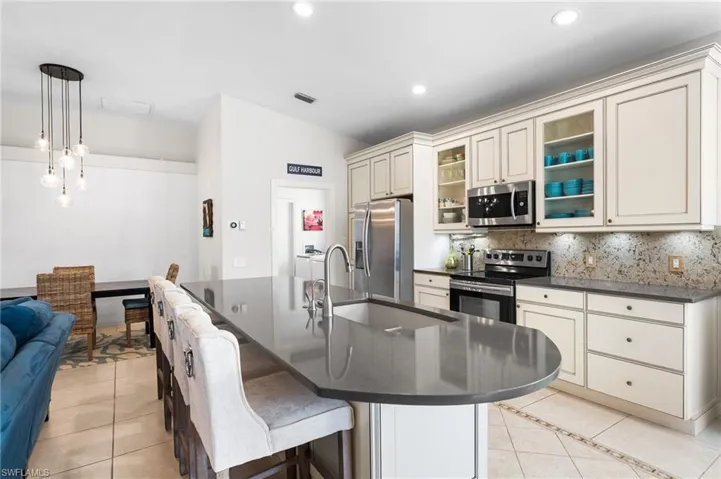 Quartz countertops large island is so inviting to gather around while the chef cooks their favorite meal!