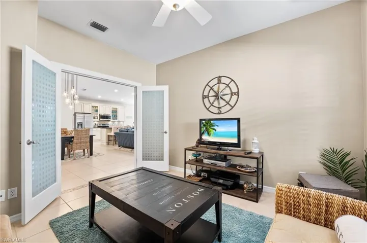 Frosted glass french doors go into your den/office. Great space to relax and unwind to read a book, watch some T.V., a sewing room, the possibilities are endless!