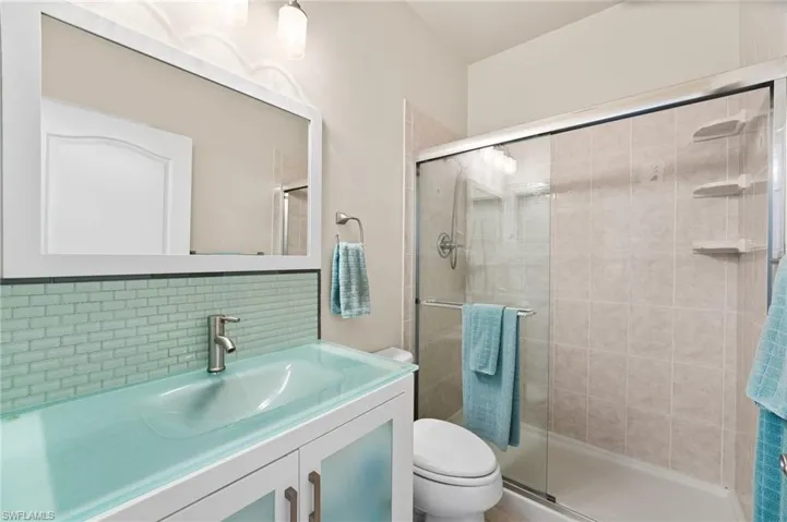 2nd full bath has a custom underlit vanity and a walk in shower.