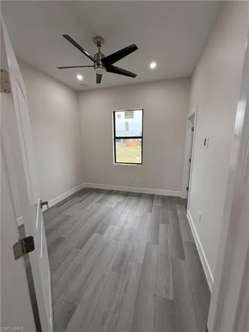Spare room with light wood-style floors, recessed lighting, and a ceiling fan