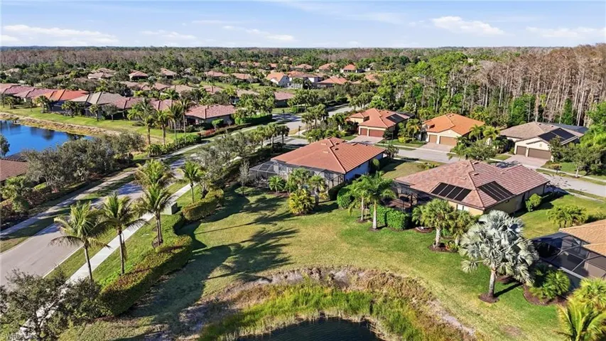 Aerial view of residential area featuring a nearby body of water