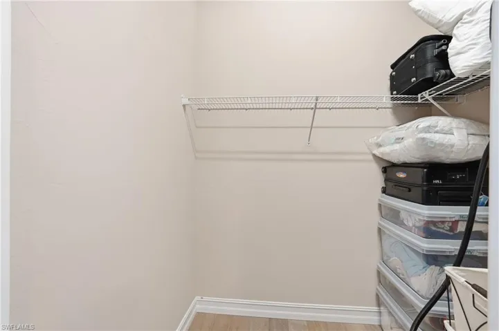 Walk in closet featuring light wood-style flooring