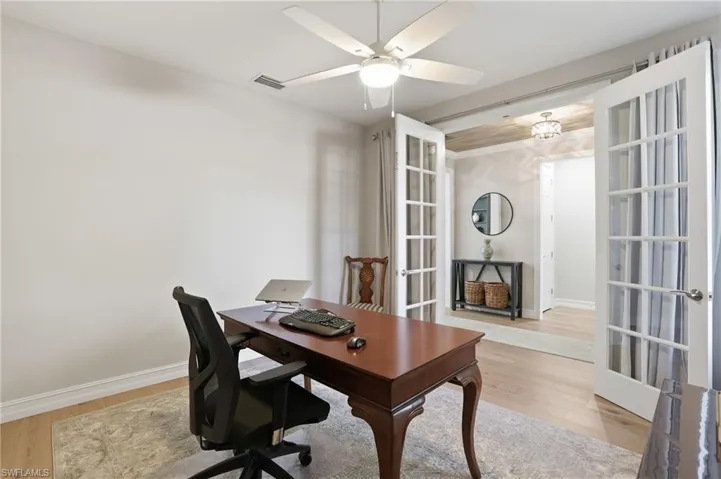 Office featuring light wood-style flooring, french doors, and ceiling fan
