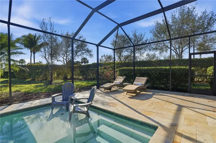 Swimming pool featuring a sunroom and a private landscaped yard.