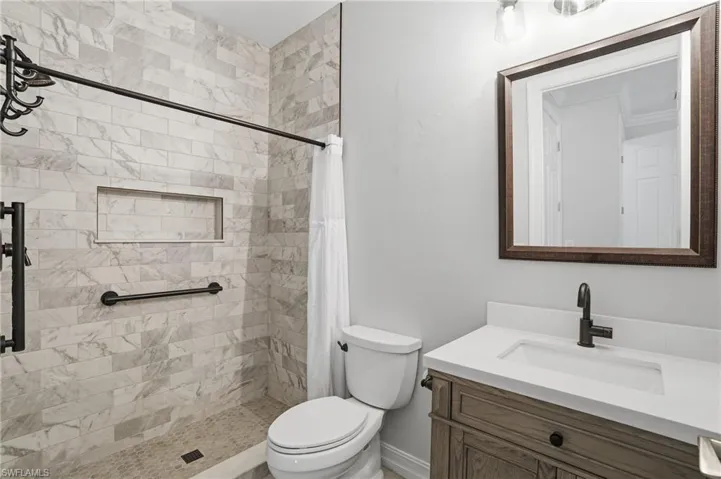 Bathroom with vanity and a shower stall