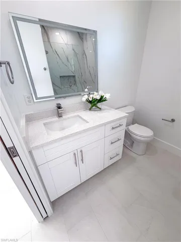 Guest bathroom featuring vanity and toilet
