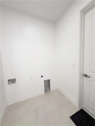 Laundry room with hookup for a washing machine and electric dryer hookup