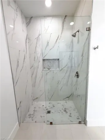 Guest bath with Porcelain finish shower and baseboards