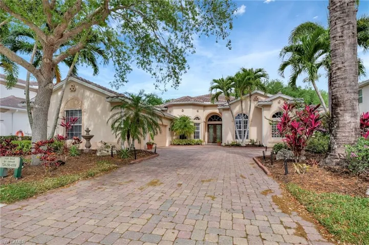 Mediterranean / spanish-style house featuring stucco siding, an attached garage, french doors, and decorative driveway