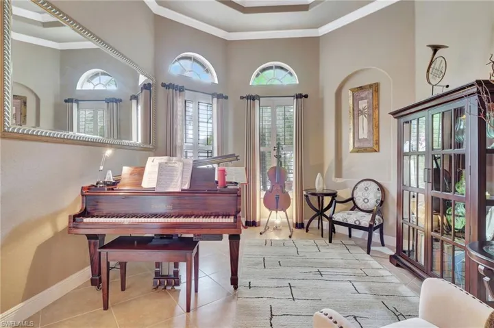 Sitting room with baseboards, crown molding, and tile patterned flooring