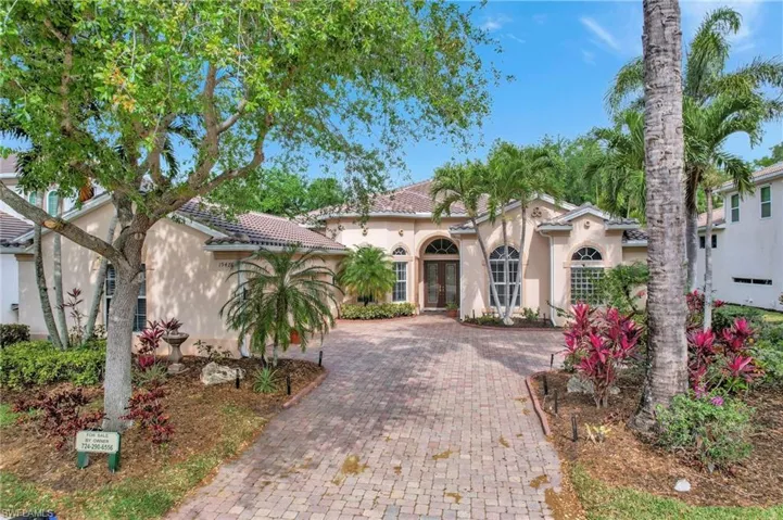 Mediterranean / spanish home featuring french doors, a tile roof, decorative driveway, and stucco siding