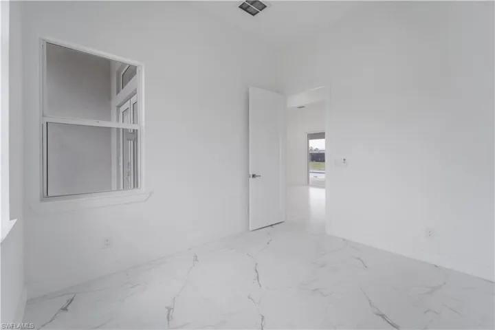 Full bath featuring marble finish floor, toilet, vanity, and a shower stall