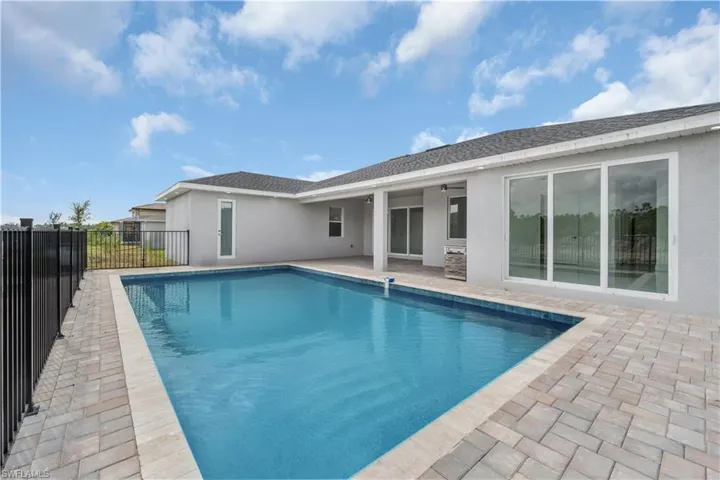 View of pool featuring fence, a fenced in pool, and a patio