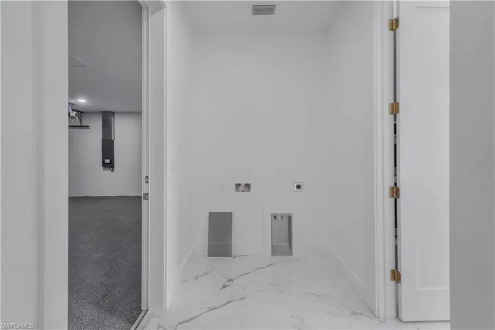 Hall featuring marble finish floor, visible vents, and baseboards
