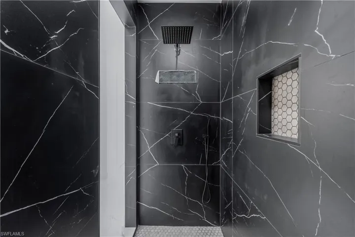 Interior details featuring a marble finish shower