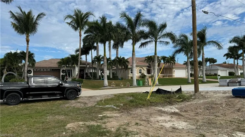 View of green lawn with a residential view