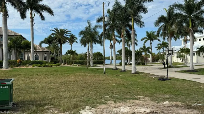 View of community featuring a water view and a lawn
