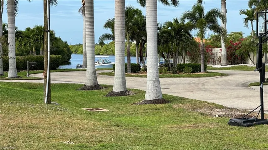 View of community with a lawn and a water view