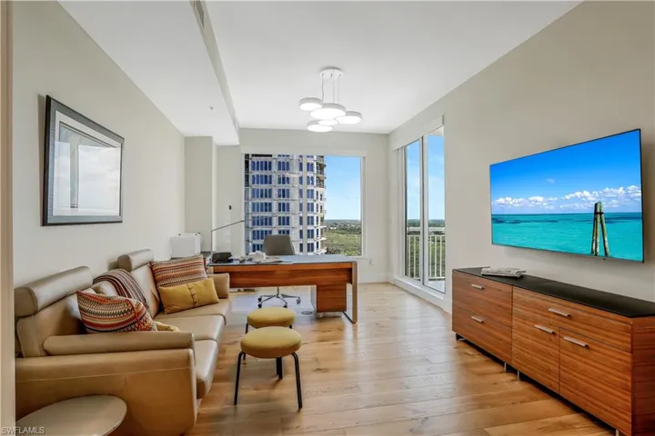 Office/den with upgraded custom woodflooring and pocket doors for privacy.