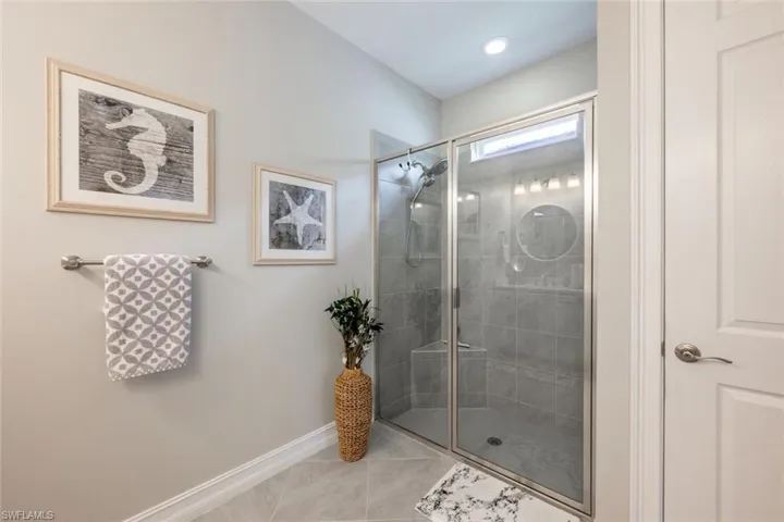 Bathroom with tile patterned floors and an enclosed shower