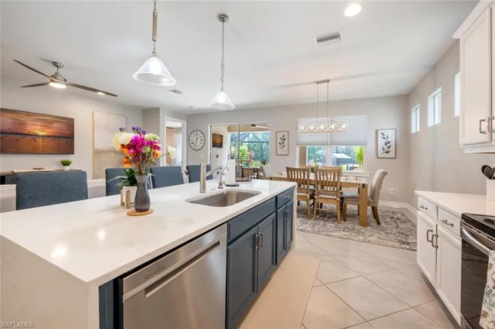 Kitchen featuring white cabinetry, appliances with stainless steel finishes, sink, and pendant lighting