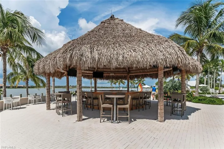 View of home's community featuring a gazebo, a water view, and an outdoor bar