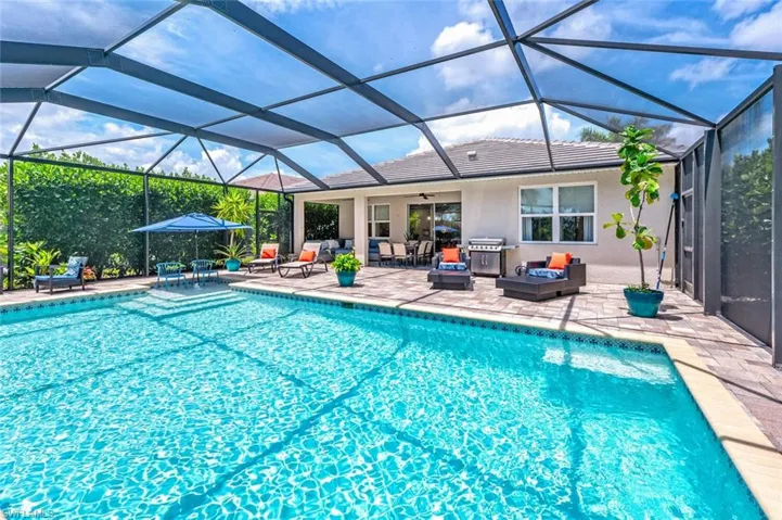 View of swimming pool with an outdoor living space, a patio area, and a lanai