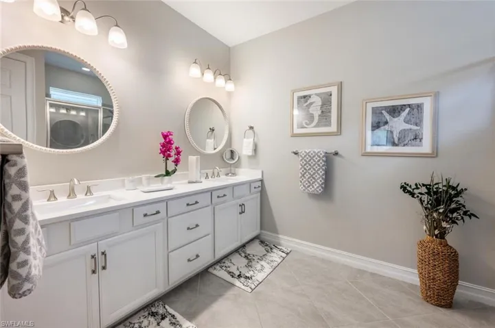 Bathroom featuring dual vanity and tile patterned flooring