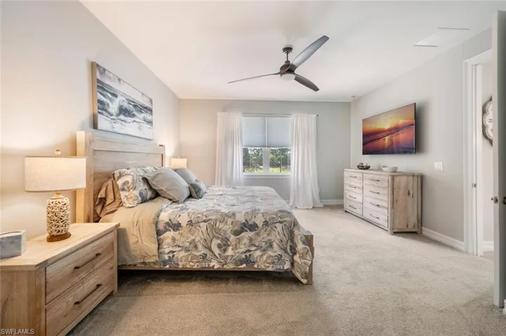 Carpeted bedroom with ceiling fan