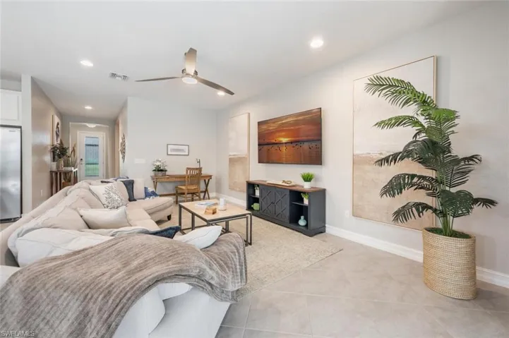 Tiled living room featuring ceiling fan