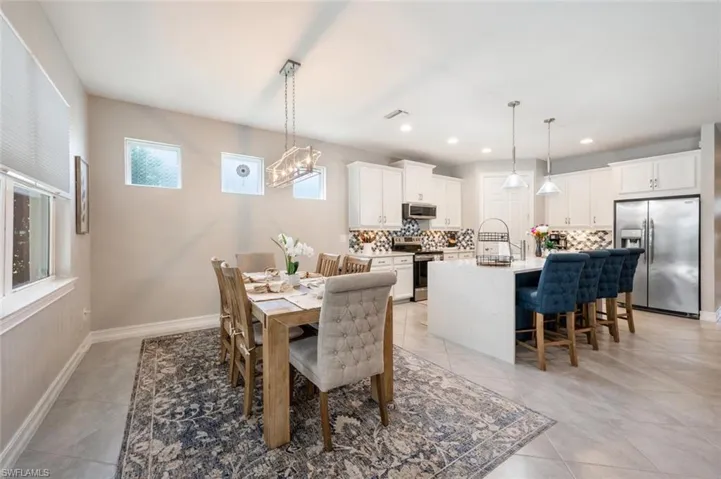 Dining room with an inviting chandelier and light tile patterned floors