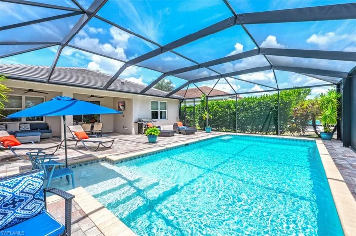 View of pool with area for grilling, a patio area, a lanai, and ceiling fan
