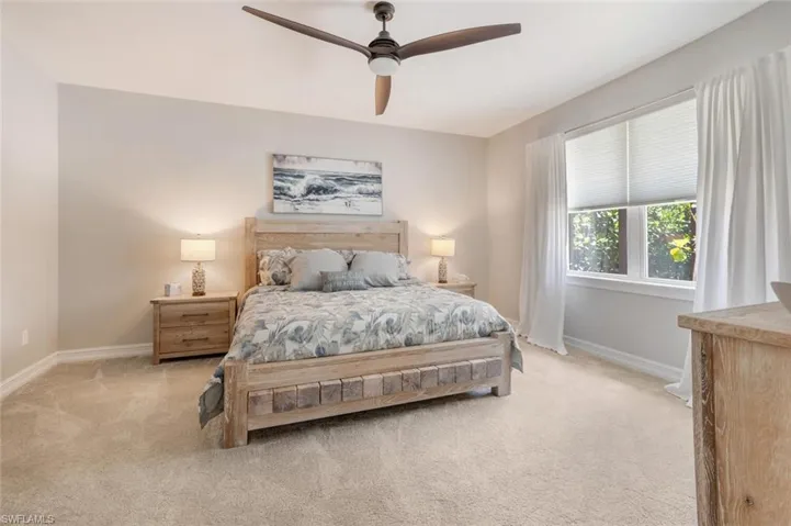 Bedroom with light carpet and ceiling fan