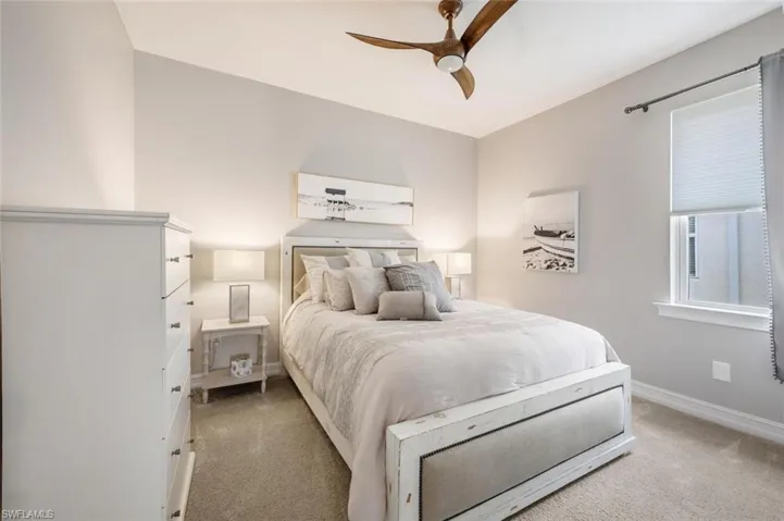 Bedroom featuring light colored carpet and ceiling fan