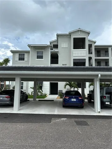 View of parking with a carport