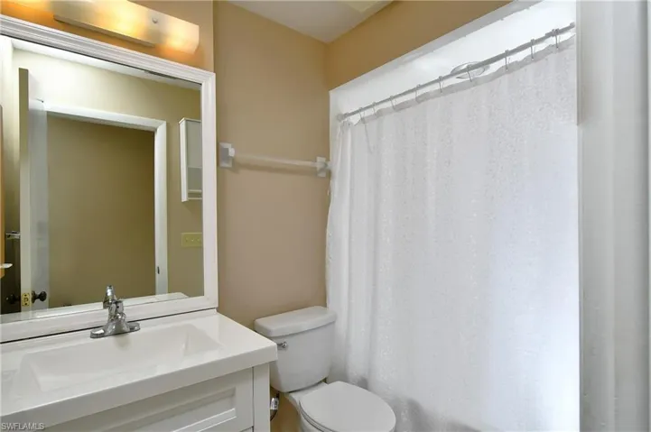 Bathroom located in the hallway with a combo tub and shower