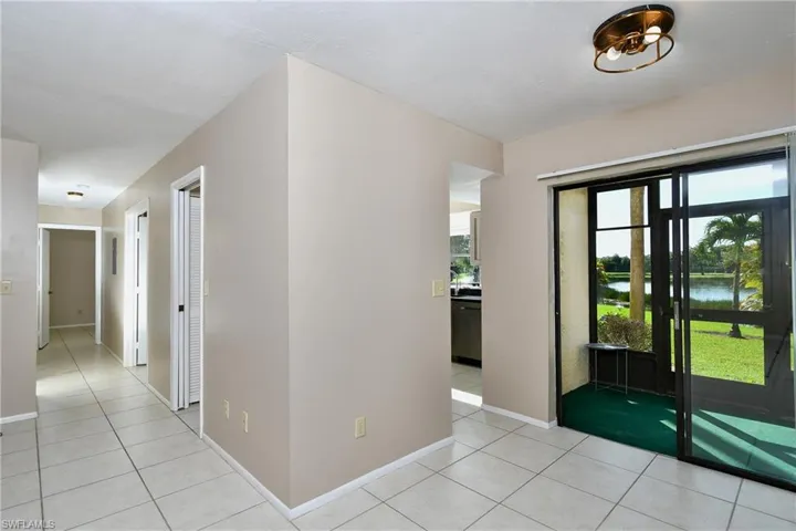 From the LR & DR looking down the hallway leading to the 2 Bedrooms, laundry room and hall bath; kitchen and lanai off to the Rt
