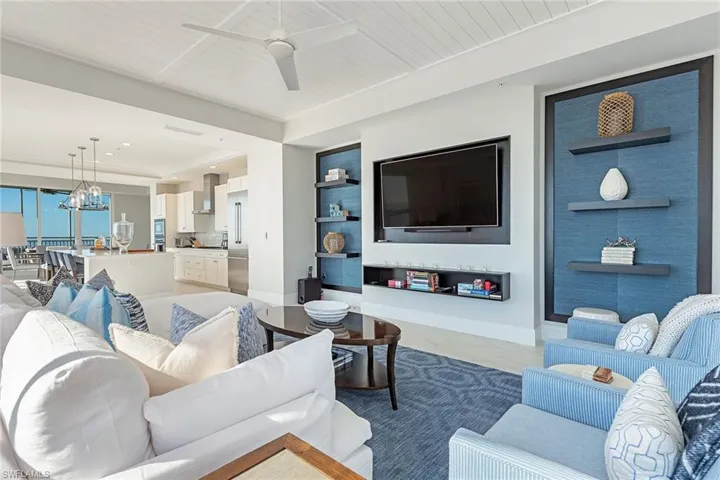 Living area featuring wood ceiling, a chandelier, and a ceiling fan