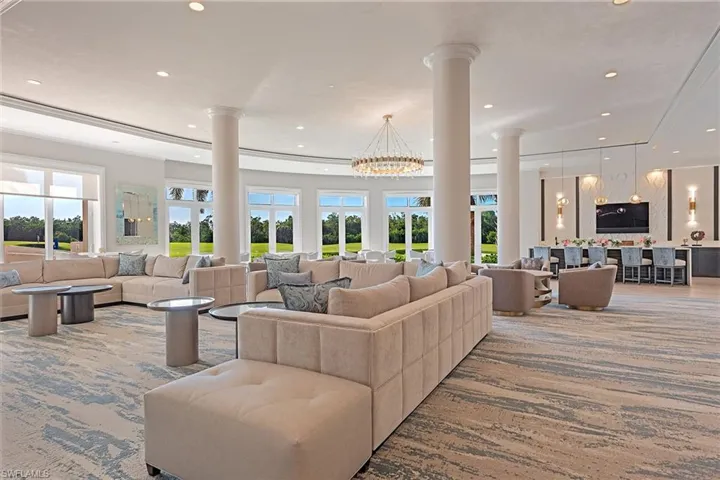 Living room featuring a chandelier, recessed lighting, and ornate columns